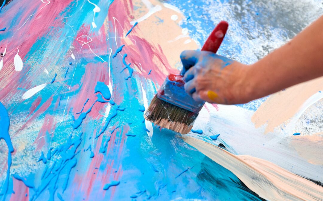 Drip painting expression art on canvas with blue, pink and beige colors, artist art performance